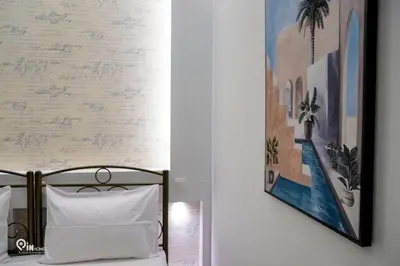 a bedroom with a bed and a painting on the wall at The Mint - Stylish Studio in Egaleo-Athens in Athens