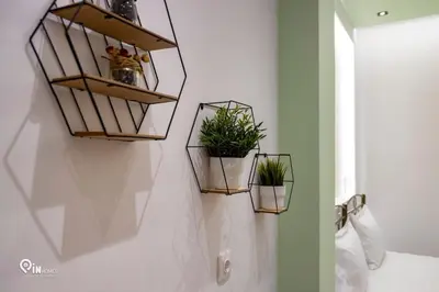 three plants in baskets on a wall in a bathroom at The Mint - Stylish Studio in Egaleo-Athens in Athens