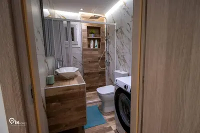 a bathroom with a toilet and a washing machine at The Mint - Stylish Studio in Egaleo-Athens in Athens