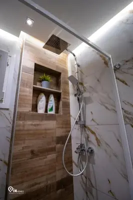 a bathroom with a shower with a sink and a shower at The Mint - Stylish Studio in Egaleo-Athens in Athens