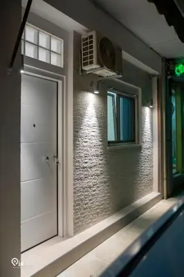 a door in a room with a brick wall at The Aqua - Stylish & Comfy Studio in Egaleo-Athens in Athens