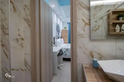 a bathroom with a sink and a mirror at The Aqua - Stylish & Comfy Studio in Egaleo-Athens in Athens