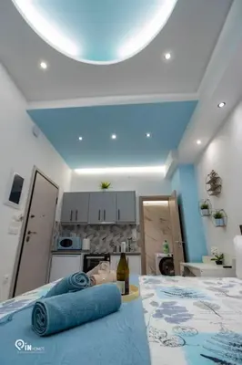 a room with a bed with two blue towels on it at The Aqua - Stylish & Comfy Studio in Egaleo-Athens in Athens