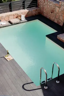 a swimming pool with blue water in a building at Villa GEM in Porto Rafti