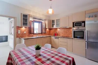 a kitchen with a table with a plaid table cloth at Villa GEM in Porto Rafti