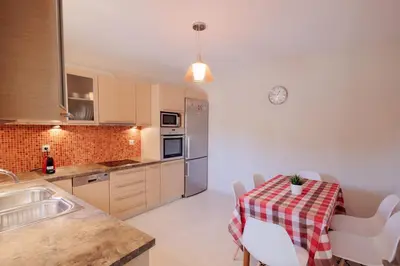 a kitchen with a table with a table cloth on it at Villa GEM in Porto Rafti