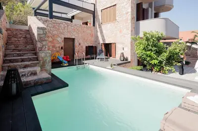a swimming pool in the backyard of a house at Villa GEM in Porto Rafti