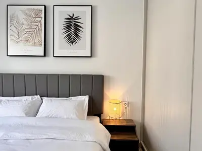 a bedroom with two framed prints of leaves on the wall at Chic Getaway Near Stavros Niarchos in Athens
