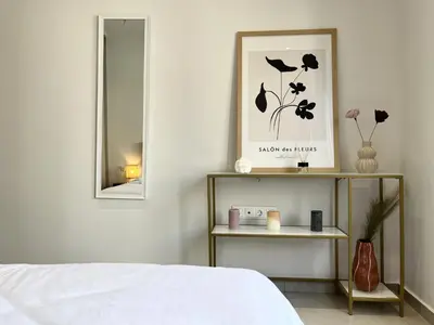 a bedroom with a bed and a mirror and a shelf at Chic Getaway Near Stavros Niarchos in Athens