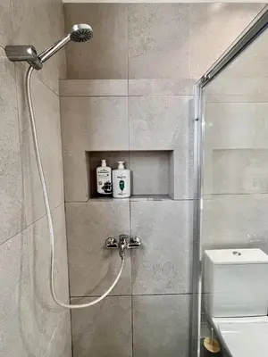 a bathroom with a shower and a toilet at Chic Getaway Near Stavros Niarchos in Athens
