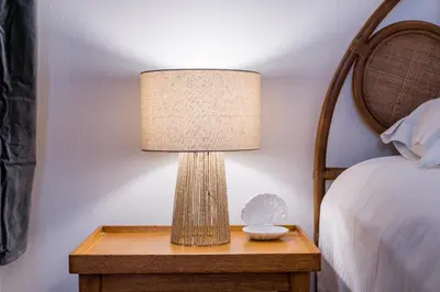 a lamp on a table next to a bed at Pistachio in Athens