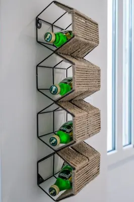 a wine rack with bottles of wine in a wall at Pistachio in Athens