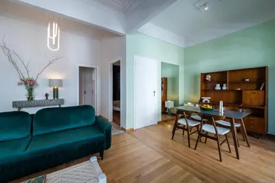 a living room with a green couch and a table at Pistachio in Athens