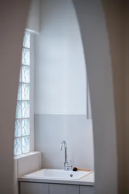 a white kitchen with a sink and a window at Pistachio in Athens