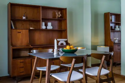 a dining room table and chairs with a bowl of fruit on it at Pistachio in Athens