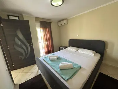 a bedroom with a bed with two towels on it at Riviera Beach apart no 5 in Anavissos