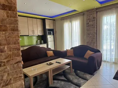 a living room with a couch and a coffee table at Riviera Beach apart no 5 in Anavissos