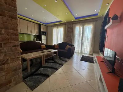 a living room with a couch and a table at Riviera Beach apart no 5 in Anavissos