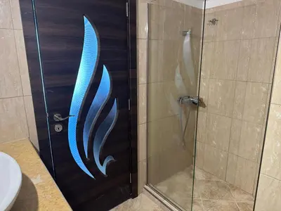 a shower stall with a blue fish painted on it at Riviera Beach apart no 5 in Anavissos