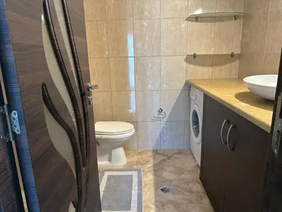 a bathroom with a toilet and a sink at Riviera Beach apart no 5 in Anavissos