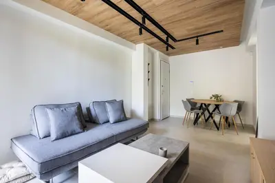 a living room with a couch and a table at Athens Sea Side Escape in Vari