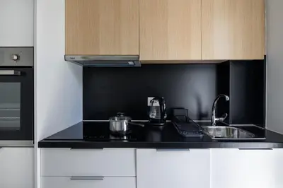 a kitchen with a black counter top and a sink at Athens Sea Side Escape in Vari