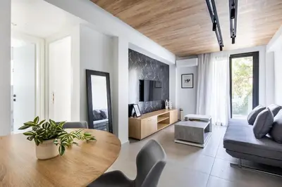 a living room with a table and a couch at Athens Sea Side Escape in Vari
