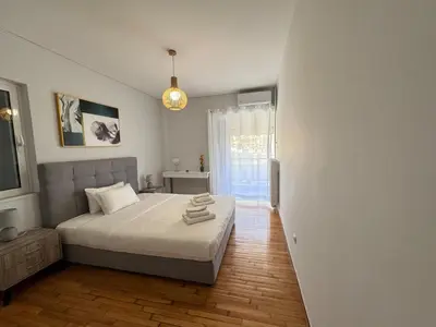 a bedroom with a large bed and a window at South coast -- AL020 in Athens