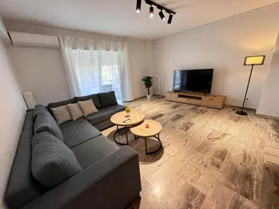 a living room with a couch and a tv at South coast -- AL020 in Athens