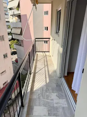 a corridor of a building with a balcony at South coast -- AL020 in Athens