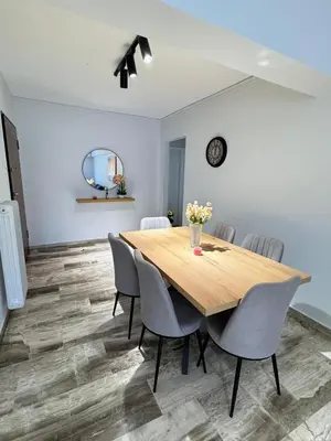 a dining room with a wooden table and chairs at South coast -- AL020 in Athens