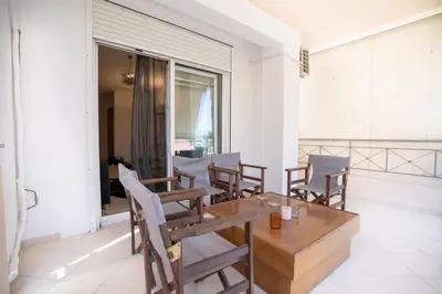 a dining room with chairs and a table and a window at Koropi 3 bedroom Luxurious Apartment 5 pers- Angel House in Koropíon