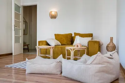 a living room with a couch and pillows on the floor at Honey in Athens