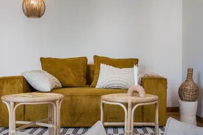 a living room with a couch and two tables at Honey in Athens