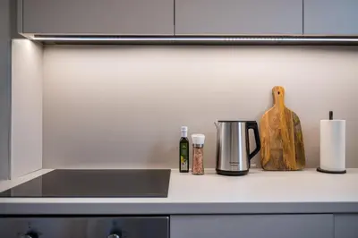 a kitchen counter top with a coffee pot and a wooden object at Honey in Athens