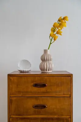 a table with a vase and a flower on it at Honey in Athens