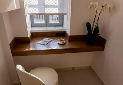a desk in a room with a window and a chair at Maison 36 Villa in the center of Psyri in Athens