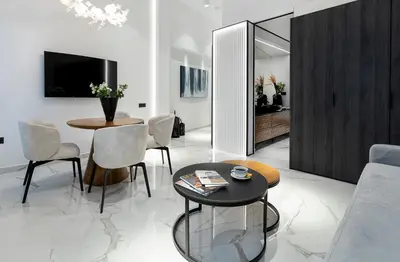a living room with a table and chairs at Maison 36 Villa in the center of Psyri in Athens