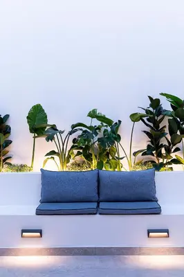 two blue pillows sitting on a table with plants at Maison 36 Villa in the center of Psyri in Athens