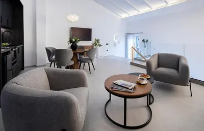 a living room with two chairs and a table at Maison 36 Villa in the center of Psyri in Athens