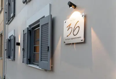 a sign on the side of a building with a window at Maison 36 Villa in the center of Psyri in Athens