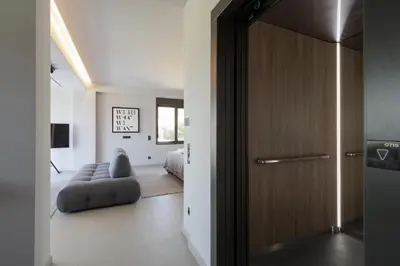 a room with a door leading to a bedroom at Experience Penthouse by Athens Riviera Suites in Saronida