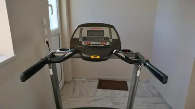 a treadmill walking down a hallway with a door at Spata sunrise house in Spáta