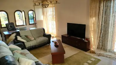 a living room with a couch and a flat screen tv at Spata sunrise house in Spáta