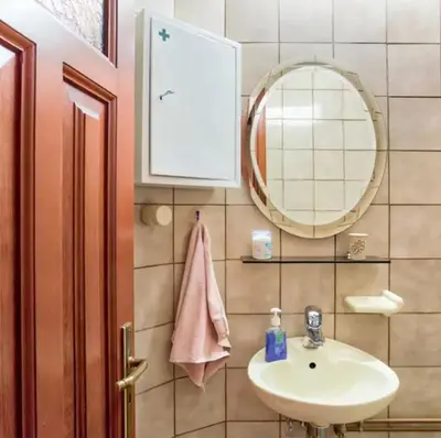 a bathroom with a sink and a mirror at Home4U, just 7km from airport in Markopoulo
