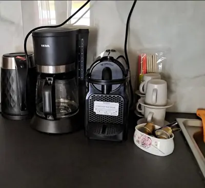 a coffeemaker sitting on a counter next to a coffee maker at Home4U, just 7km from airport in Markopoulo