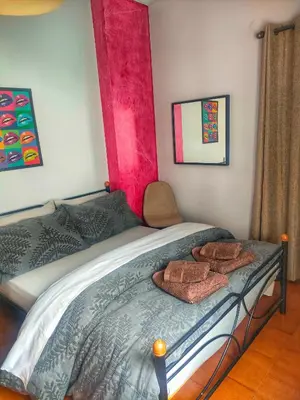 a bedroom with a bed with two towels on it at Home4U, just 7km from airport in Markopoulo