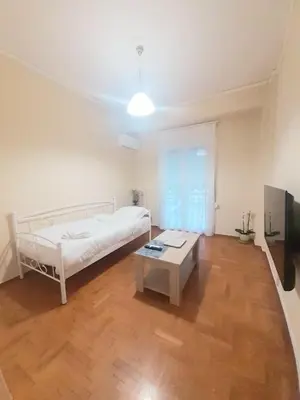 a bedroom with a bed and a table in it at A-Apartments -- Agiou Therapontos in Athens