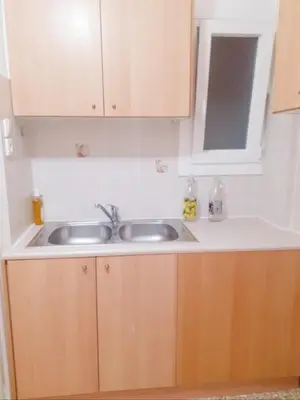 a kitchen counter with two sinks and a mirror at A-Apartments -- Agiou Therapontos in Athens