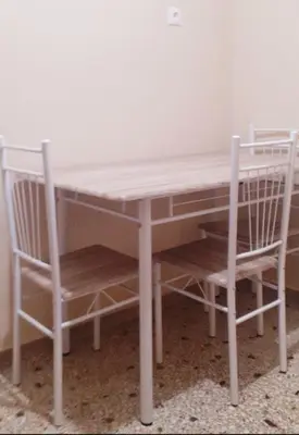 a table and two chairs sitting next to a table at A-Apartments -- Agiou Therapontos in Athens